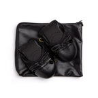 Black Talaria Flats shoes with sleek, minimalist design featuring smooth black leather and a comfortable flat sole.