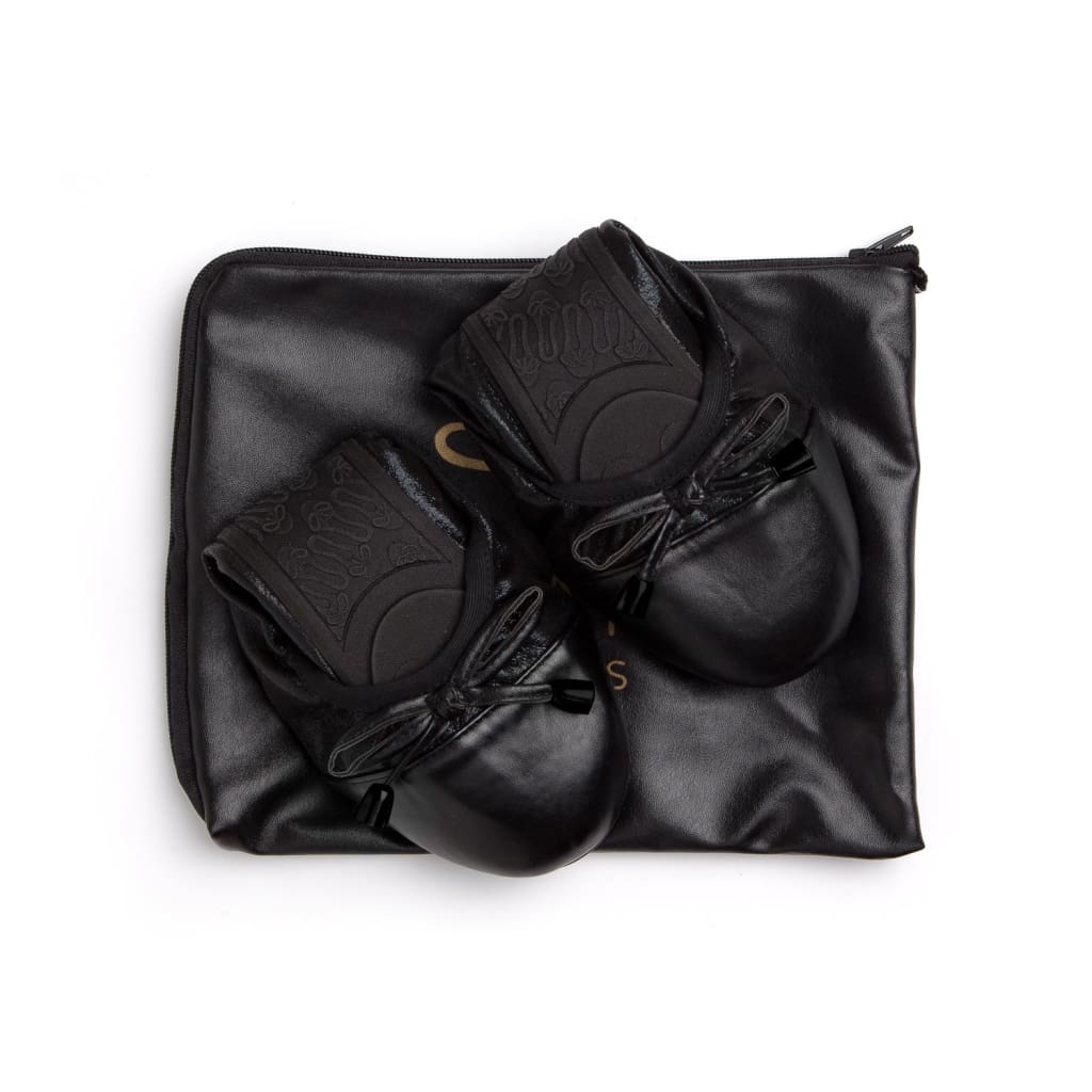 Black Talaria Flats shoes with sleek, minimalist design featuring smooth black leather and a comfortable flat sole.