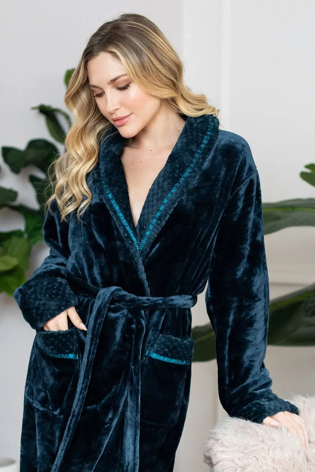 Lotus Linen women's ultra soft plush bathrobe hanging on a hook, showcasing cozy, luxurious robe fabric and relaxed fit.