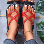 Women's faux leather flat sandals with strappy cross-strap design, comfortable and stylish shoe by Trendsi.