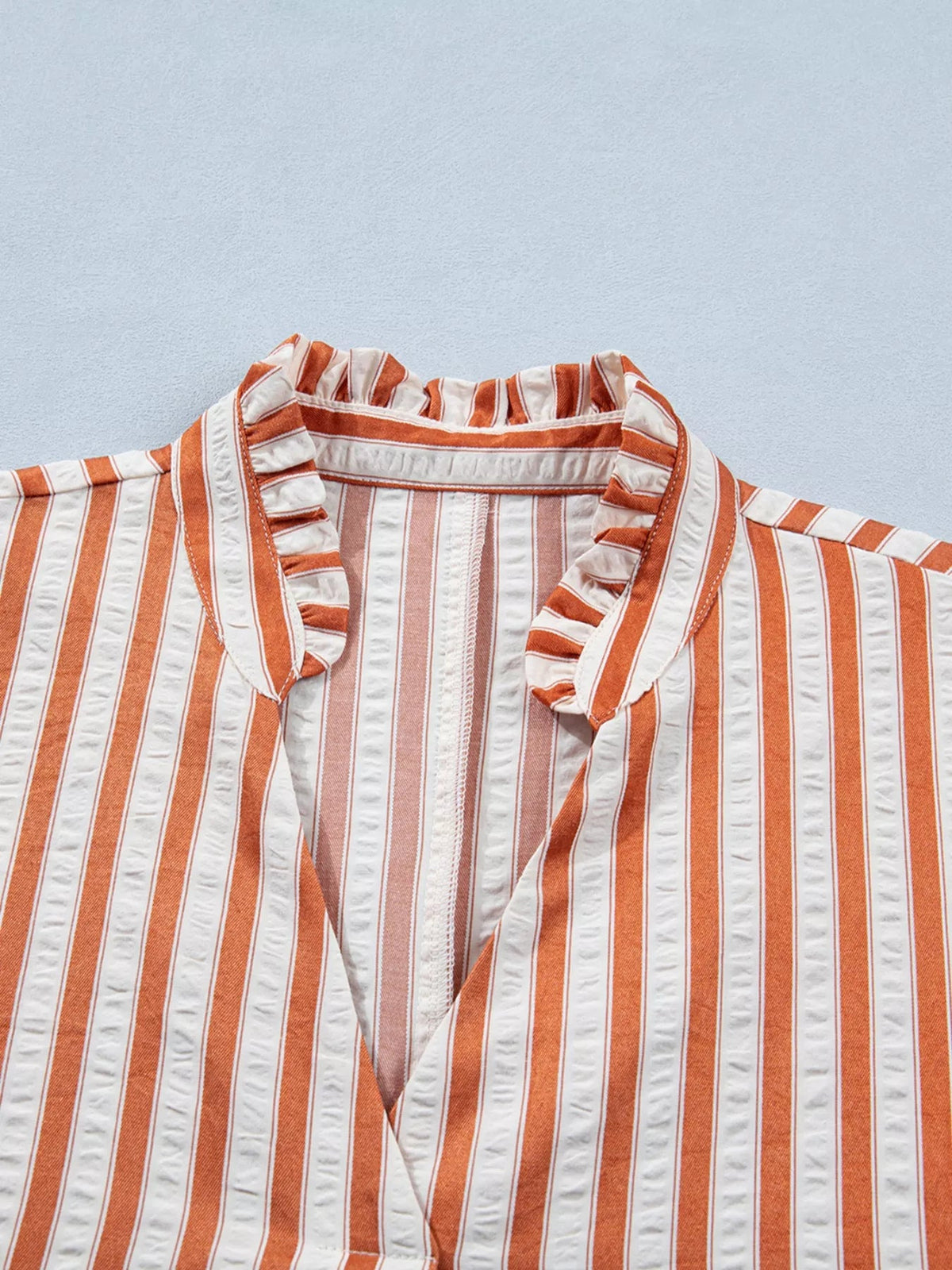 Striped V-neck mini dress by Plush Fashion Hub featuring turn-up cuffs and pockets, perfect for casual and stylish wear.