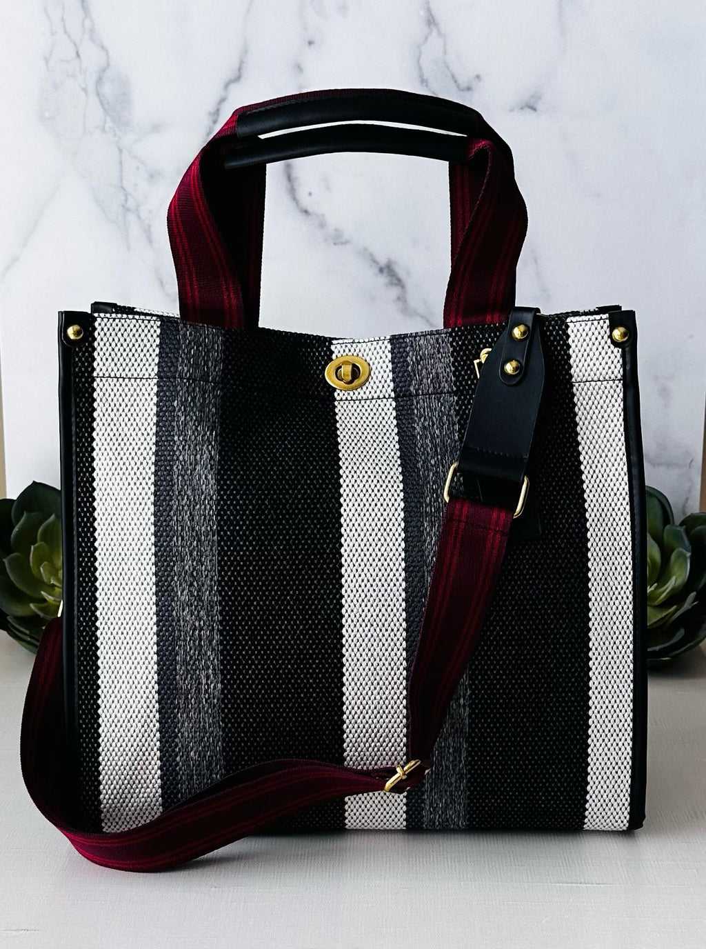 LadyShow.Store stripe tote bag with white and black striped design, featuring sturdy handles and spacious interior.
