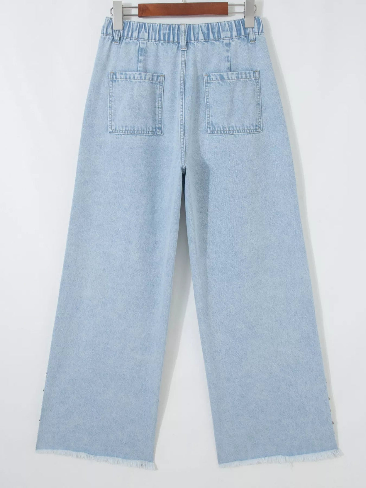 Plush Fashion Hub studded wide-leg jeans with frayed hem and side slits, showcasing distressed denim and trendy details.