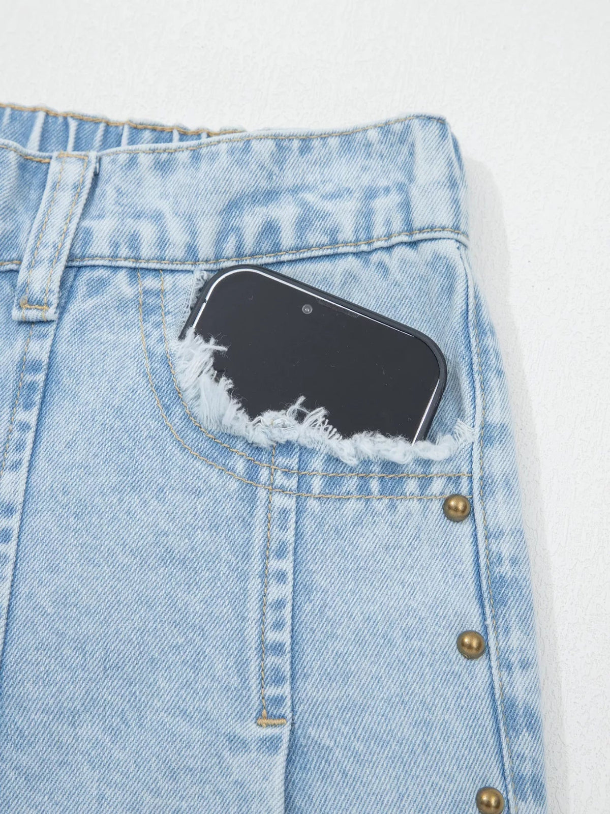Plush Fashion Hub studded wide-leg jeans with frayed hem and side slits, showcasing distressed denim and trendy design details.