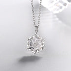 Silver snowflake necklace with diamond pendant, stylish jewelry piece showcasing a delicate winter-inspired design.