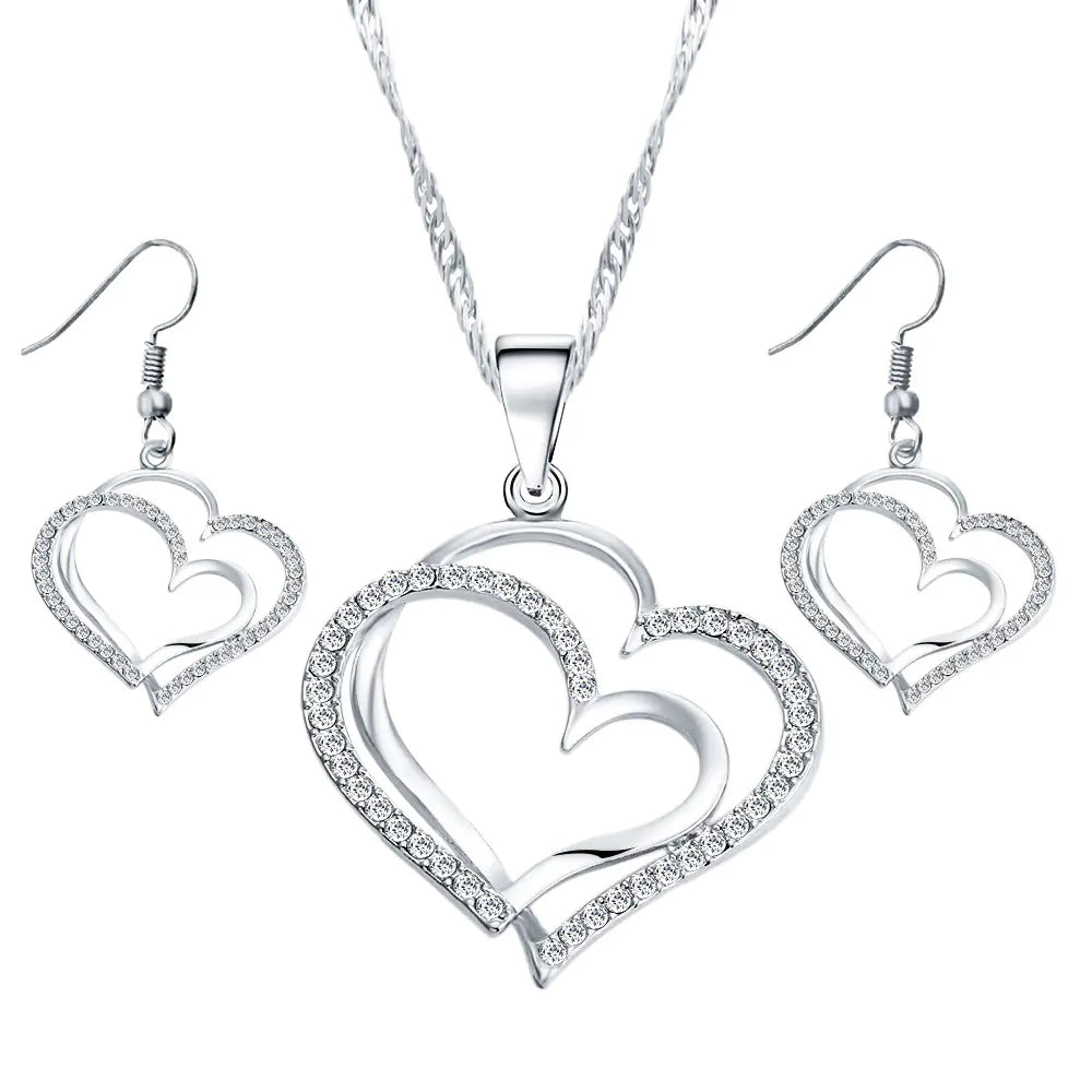 Double heart earrings and necklace wedding set, gold-tone jewelry with matching heart-shaped pendants and earrings.