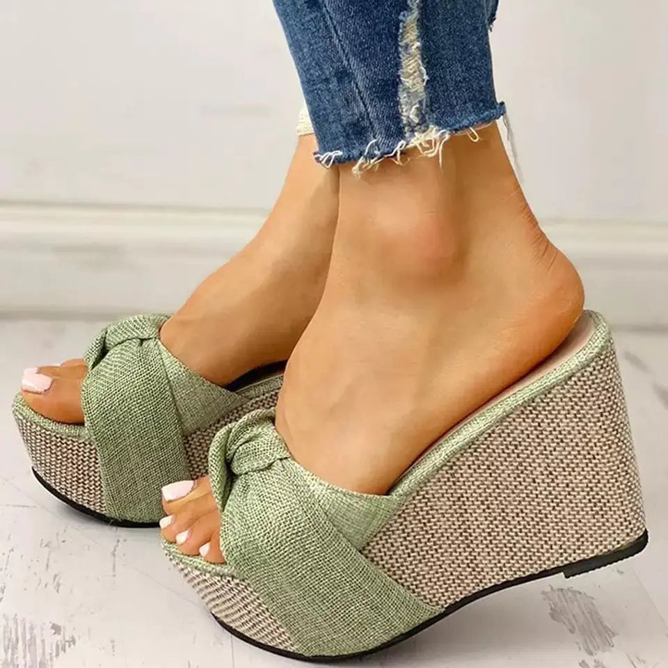 Women’s bow sandals by Trendy Attic Store01 featuring a stylish slip-on design and comfortable flat sole.