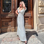 Elegant V-neck maxi dress by Bella Mia featuring puff sleeves, polka dots, lace-up waist, and a slim fit for a stylish look.