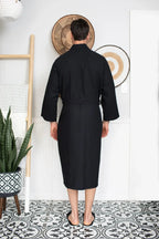 Men's Waffle Spa Bathrobe by Lotus Linen, lightweight and absorbent, shown hanging with a shawl collar and long sleeves.