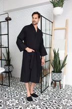 Absorbent, lightweight Waffle Spa Bathrobe for Men by Lotus Linen, shown draped on a hanger with a soft, textured waffle fabric.