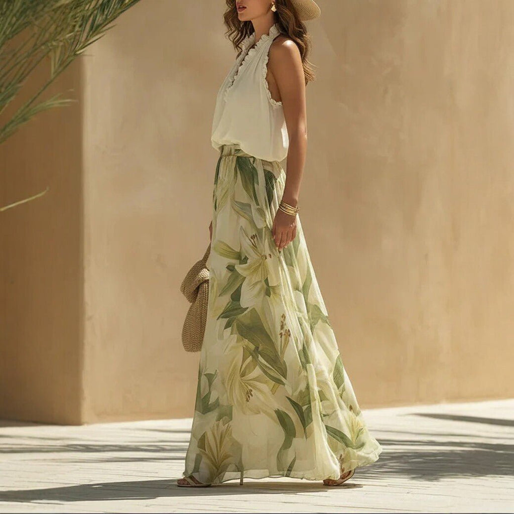 Printed maxi dress by FitiqueFit featuring waist-cinching design, ruffle hem, and vibrant floral print, available in sizes S to 3XL.