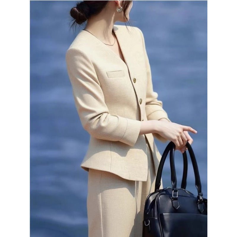 Beige waist-grabbing coat with wide-leg pants set by FitiqueFit, stylish and elegant, shown on a model.
