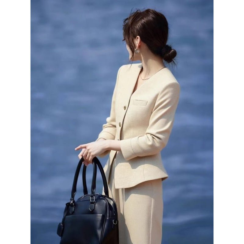 Beige waist-grabbing coat paired with wide-leg pants from FitiqueFit, stylishly displayed on a model.