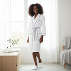 White knee-length waffle robe for women by Lotus Linen, soft and cozy with a relaxed fit, perfect for comfortable loungewear.