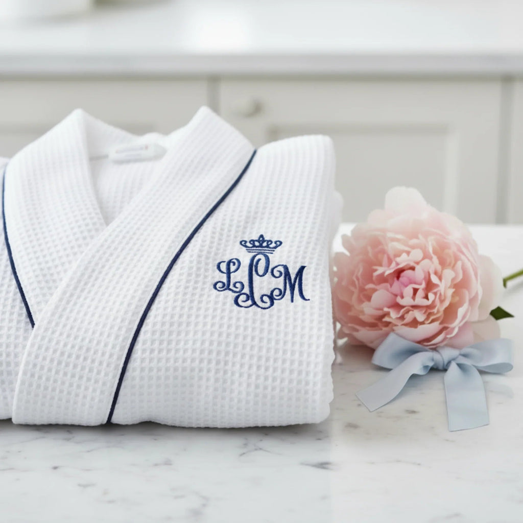 White knee-length waffle robe for women by Lotus Linen, soft and cozy with textured waffle fabric, ideal for lounging and relaxation.