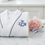 White knee-length waffle robe for women by Lotus Linen, soft and cozy with textured waffle fabric, ideal for lounging and relaxation.