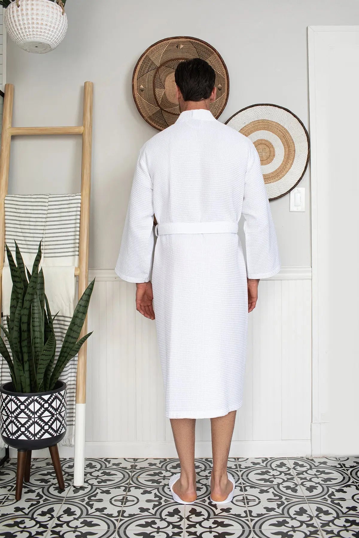 White waffle spa bathrobe for men by Lotus Linen, lightweight and absorbent, shown hanging on a hook.