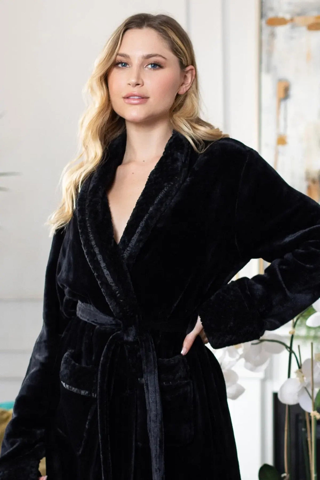 Women's ultra-soft plush bathrobe by Lotus Linen, showing a cozy, lightweight robe with a belt and pockets on a model.