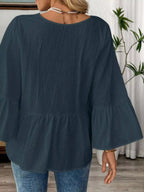 Women's 100% cotton V-neck bell sleeve blouse with a relaxed fit, showcasing effortless chic style and trendy bell sleeve design.