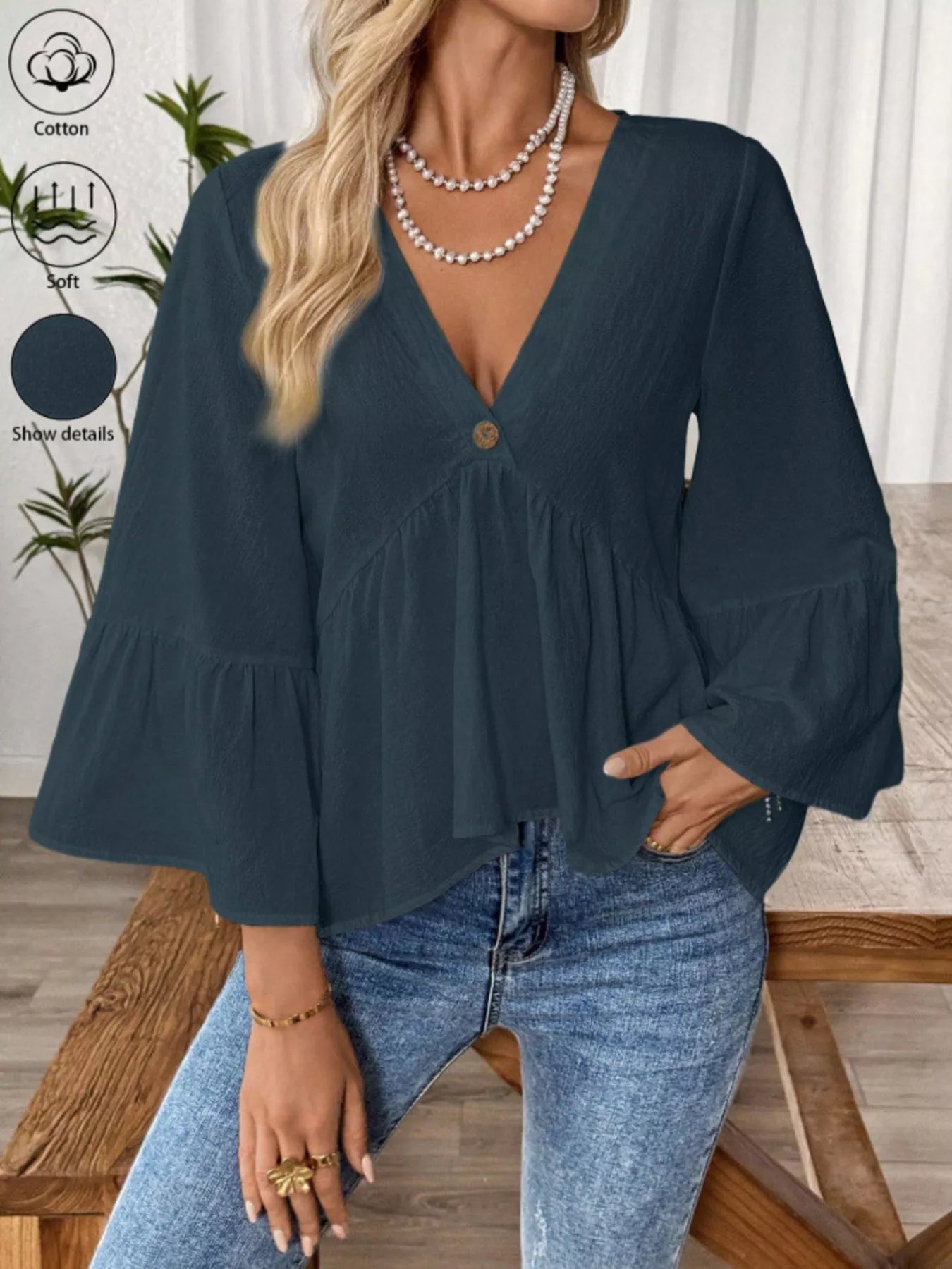 Women's white cotton V-neck blouse with bell sleeves from Trendsi, featuring a stylish and effortless chic design.