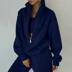 Women's 2-piece zip neck long sleeve sweatshirt and slim fit pants set by FitiqueFit, casualwear, shown on a model.