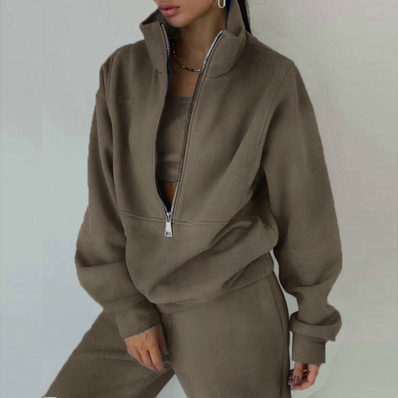 Women's casualwear 2-piece zip neck long sleeve sweatshirt and slim fit pants set by FitiqueFit, displayed on a model.