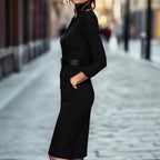 Black women's bodycon midi dress by FitiqueFit, casualwear style, shown on a model with a fitted silhouette and simple neckline.