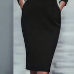 Women’s black FitiqueFit bodycon midi dress, casualwear style, fitted silhouette, sleeveless with round neckline.