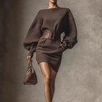 Women's brown bodycon mini dress with boat neck and long sleeves, casualwear by FitiqueFit, shown on a model.