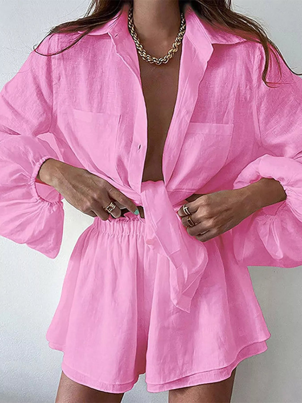 Women's long sleeve button-up shirt and shorts lounge set by Trendsi, comfortable two-piece clothing set for casual wear.