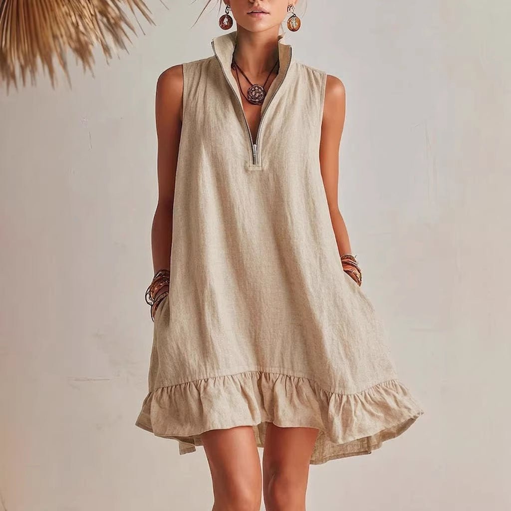 Women's casual loose sleeveless dress with half-zip front and ruffle hem by FitiqueFit, shown on a model.