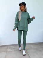 Women’s casual sweater suit by FitiqueFit with a loose split top and fitted trousers, perfect for stylish everyday wear.