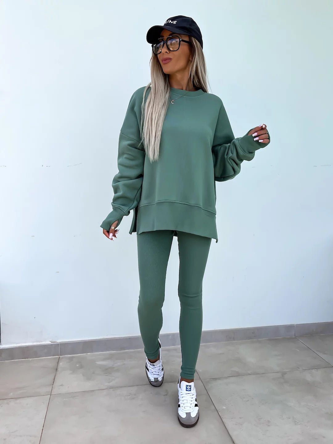 Women’s casual sweater suit by FitiqueFit with a loose split top and fitted trousers, perfect for stylish everyday wear.
