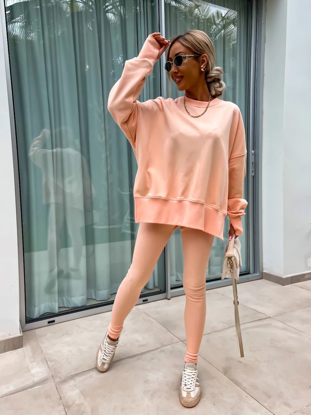 Women’s casual sweater suit by FitiqueFit featuring a loose split-top and fitted trousers, perfect for comfortable everyday wear.