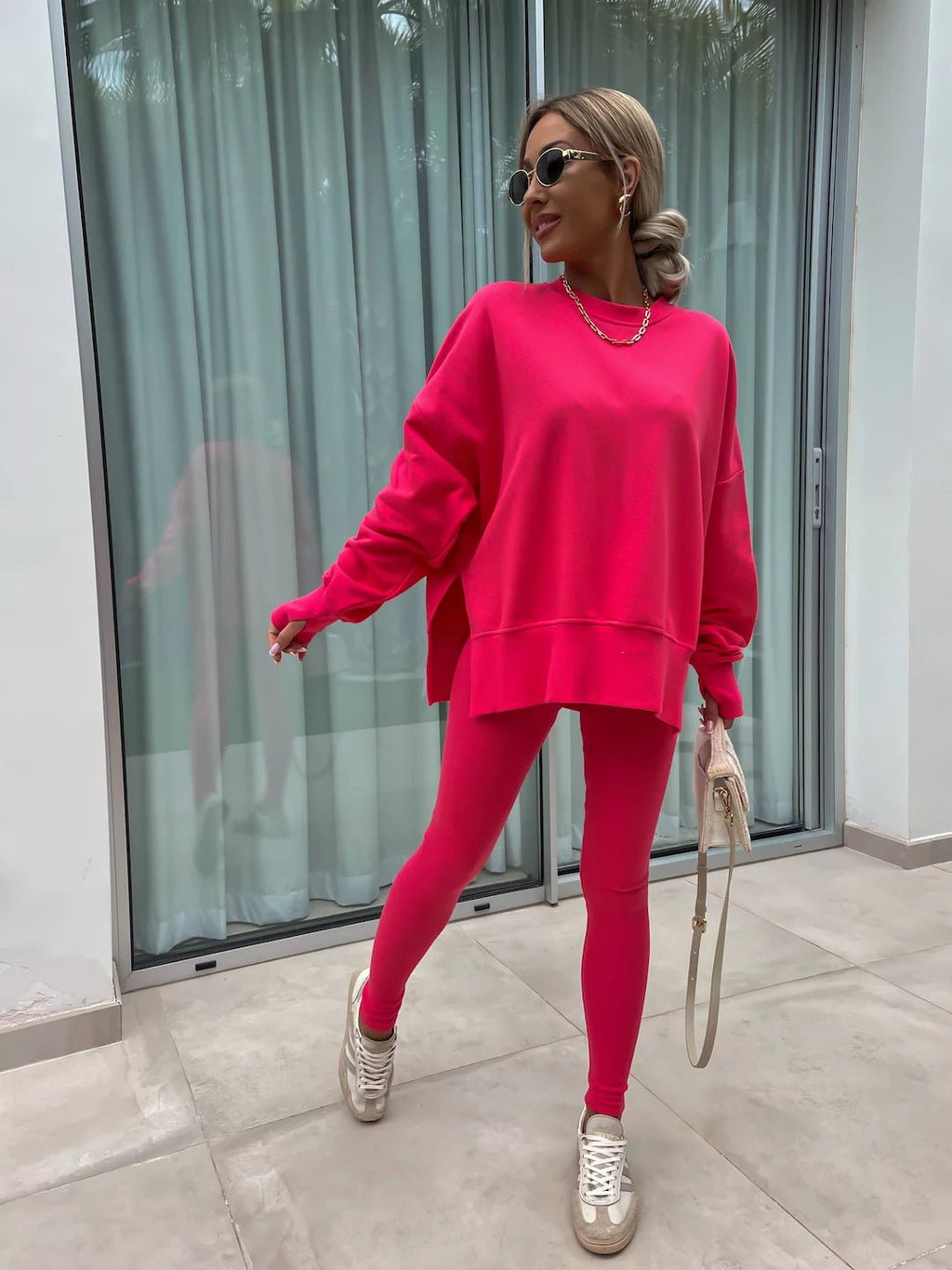 Women’s casual sweater suit by FitiqueFit featuring a loose split top and fitted trousers, ideal for comfortable everyday wear.