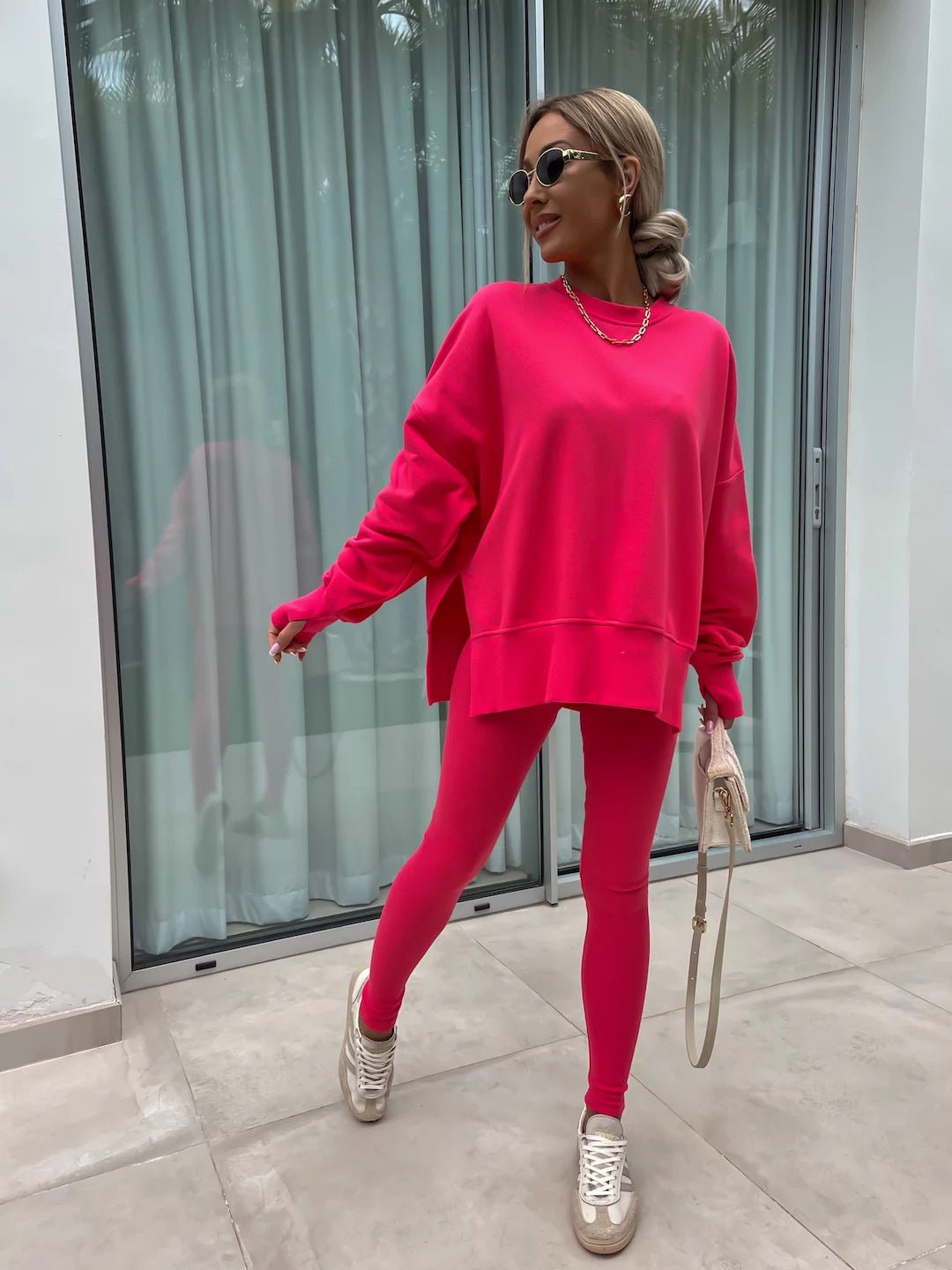 Women’s casual sweater suit by FitiqueFit featuring a loose split top and fitted trousers, ideal for comfortable everyday wear.