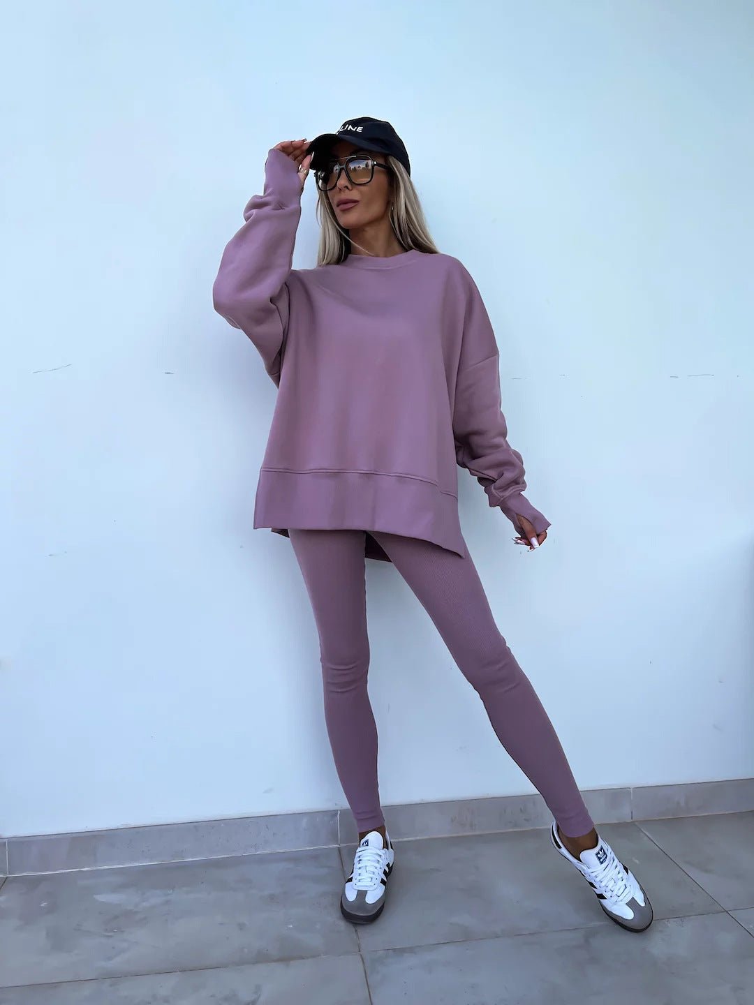 Women’s casual sweater suit by FitiqueFit, featuring a loose split top and fitted trousers, styled for relaxed everyday wear.