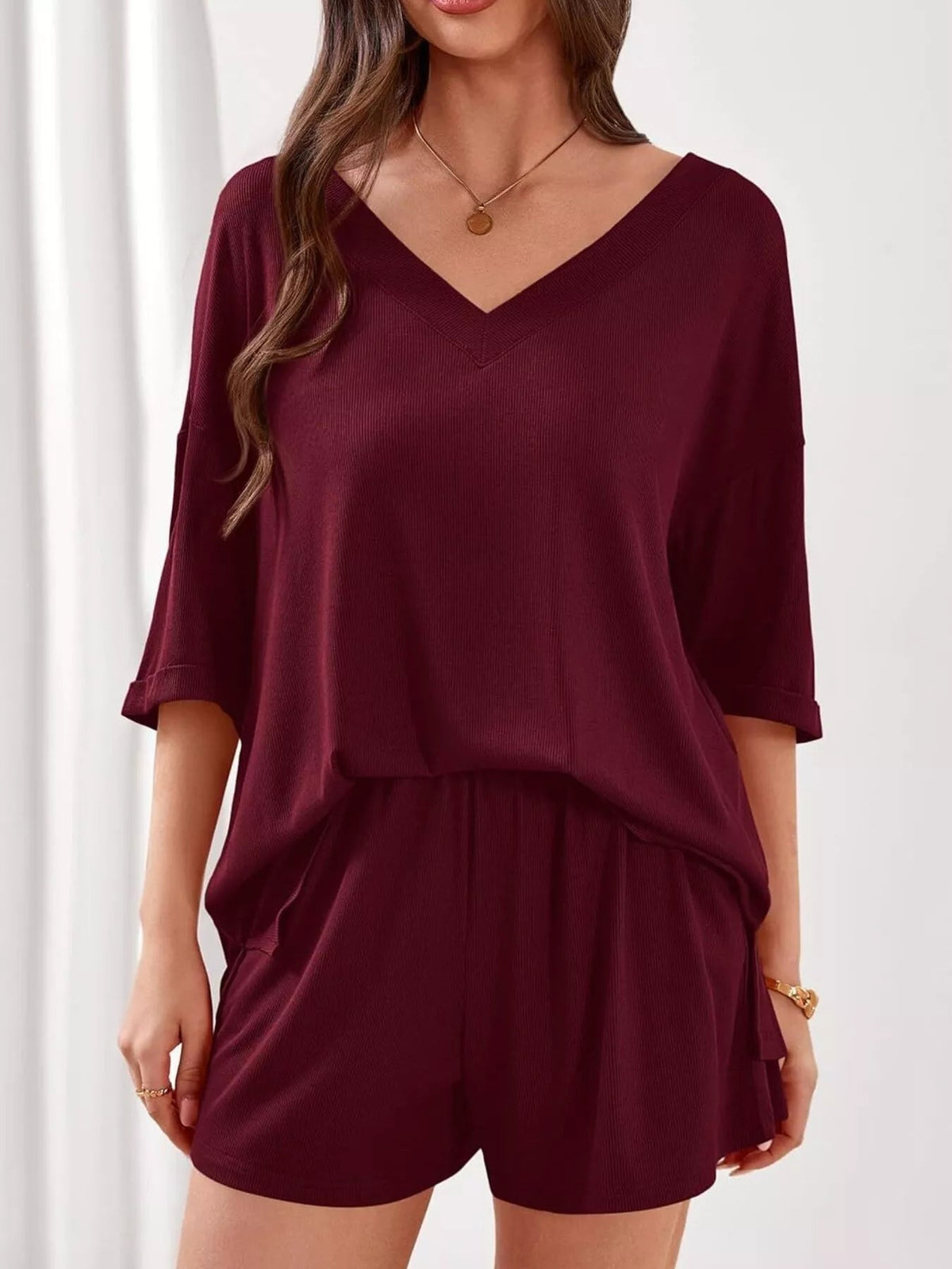 Women's casual V-neck top and shorts set by Plush Fashion Hub, solid color two-piece outfit, perfect for relaxed everyday wear.