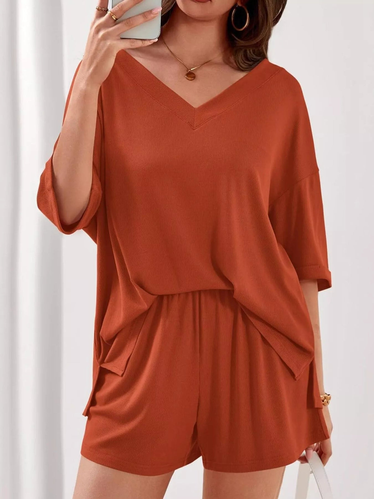 Women’s casual V-neck top and shorts set by Plush Fashion Hub, solid color two-piece outfit, perfect for relaxed everyday wear.
