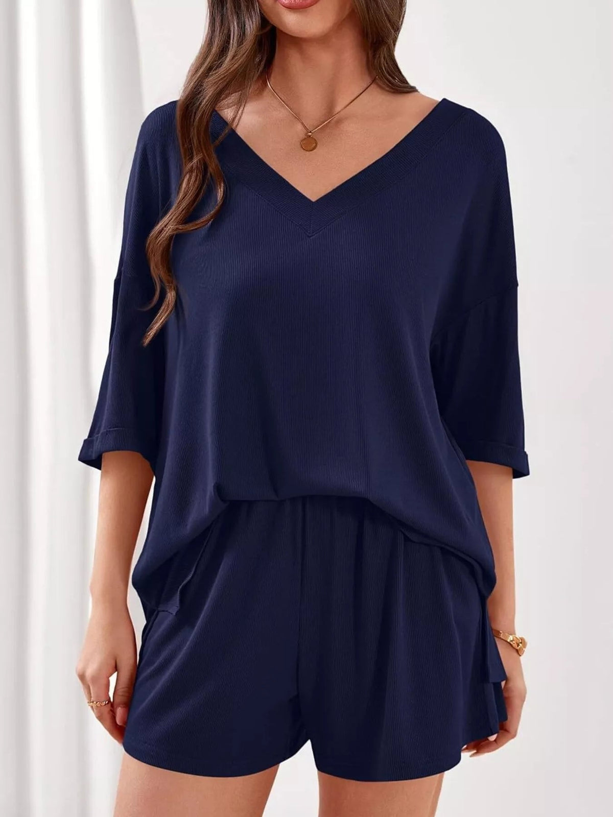 Women's casual V-neck top and shorts set in solid color, stylish two-piece outfit by Plush Fashion Hub.
