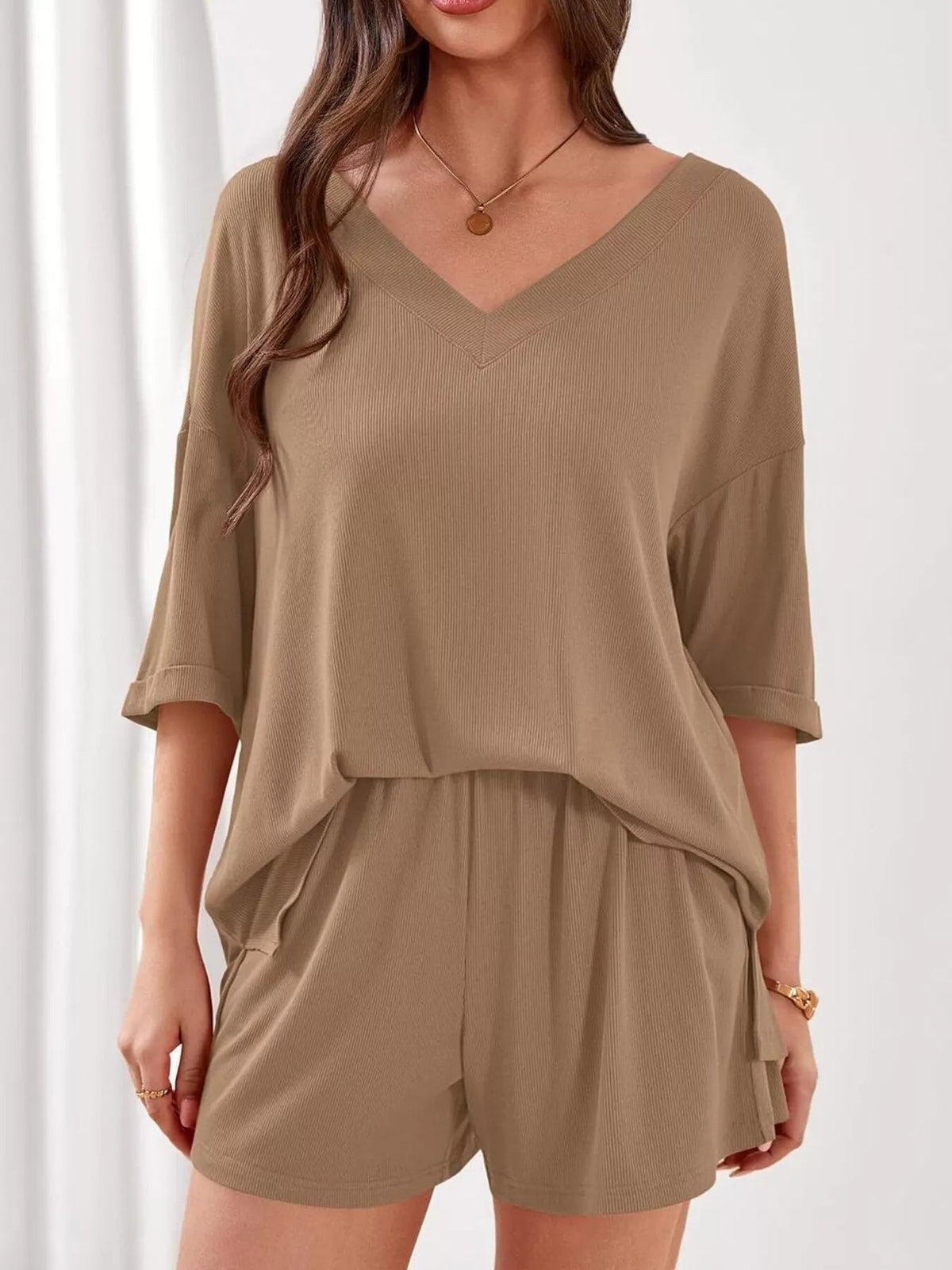 Women's casual V-neck top and shorts set from Plush Fashion Hub, solid color two-piece outfit, comfortable and stylish for everyday wear.