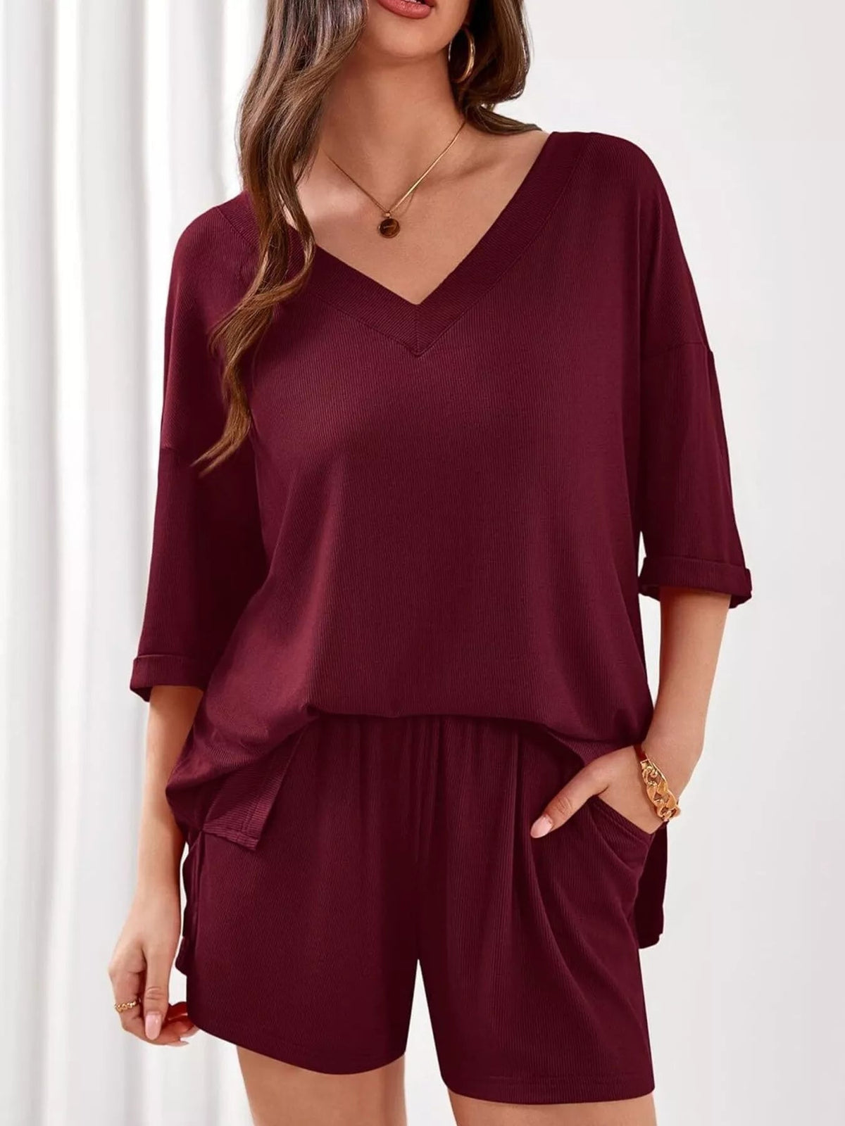 Women's casual V-neck top and shorts set from Plush Fashion Hub, solid color two-piece outfit for relaxed everyday wear.