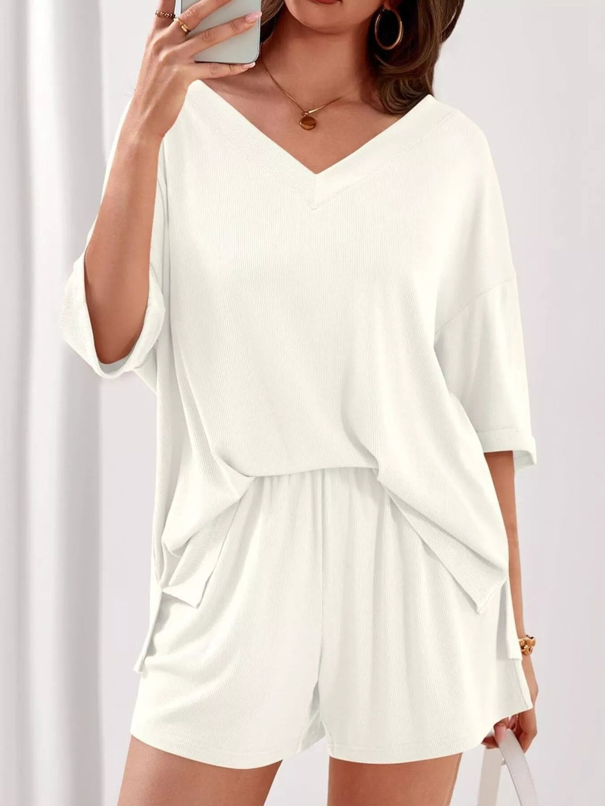 Women's casual V-neck top and shorts set in solid color, stylish two-piece outfit by Plush Fashion Hub.