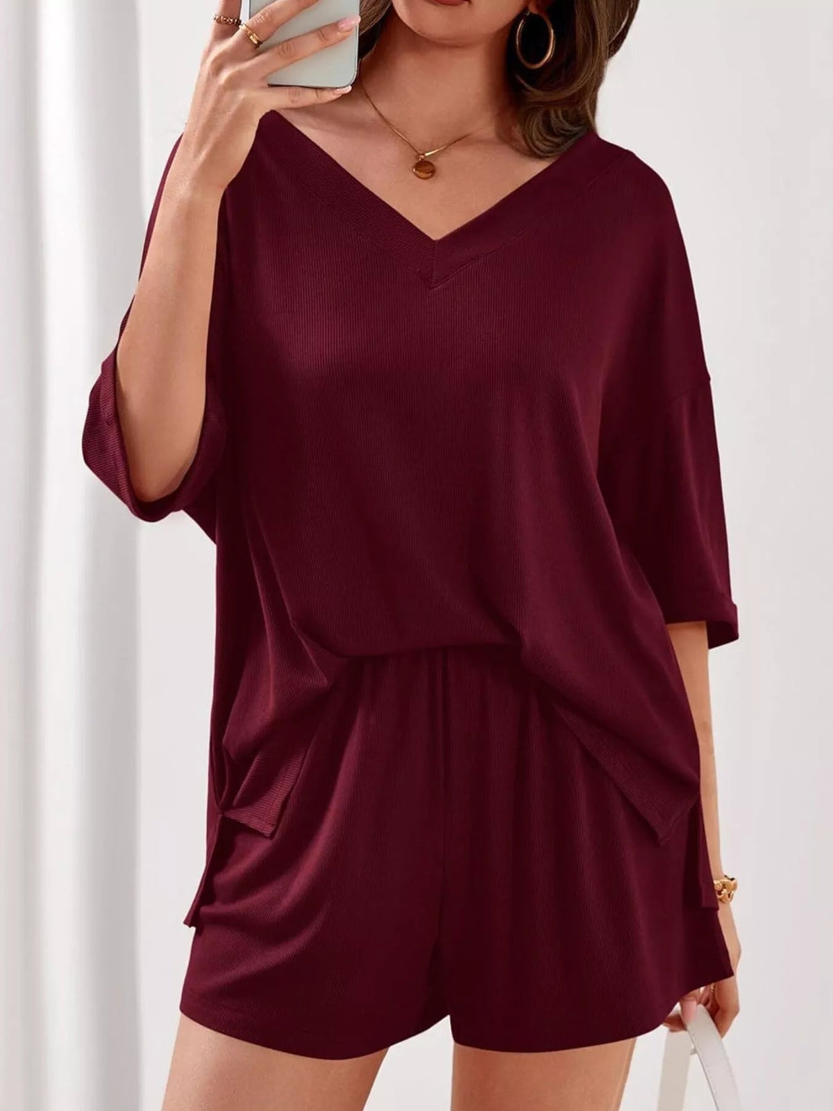 Women's casual V-neck top and shorts set, solid color two-piece outfit by Plush Fashion Hub, perfect for relaxed everyday wear.