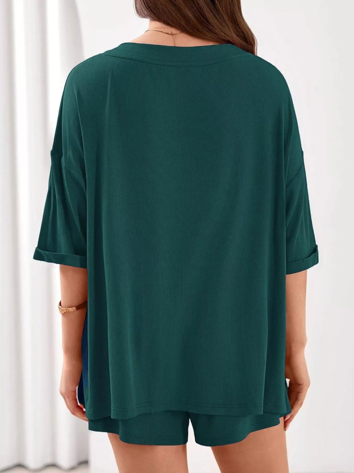 Women's casual V-neck top and shorts set by Plush Fashion Hub, solid color two-piece outfit, perfect for relaxed everyday wear.