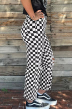 Women’s checkerboard print distressed raw edge cropped jeans by Trendsi, showcasing a trendy checkerboard pattern and frayed hem.