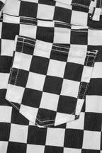 Women's checkerboard print distressed raw edge cropped jeans by Trendsi, featuring a bold black and white pattern with frayed hems.