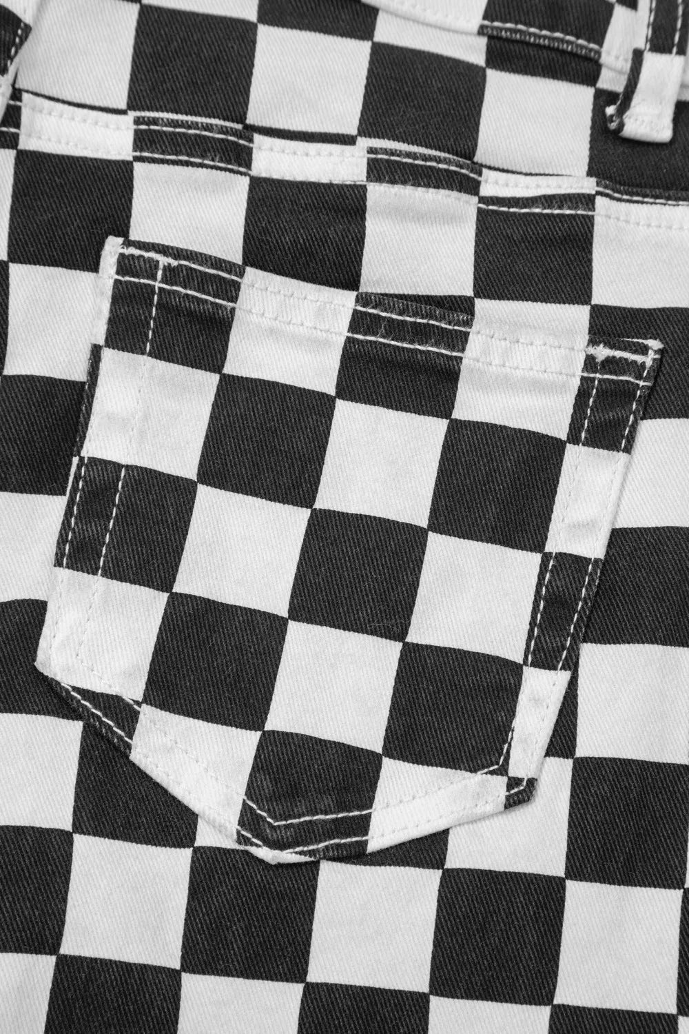 Women's checkerboard print distressed raw edge cropped jeans by Trendsi, featuring a bold black and white pattern with frayed hems.