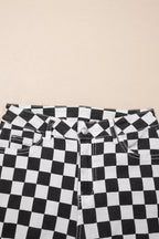Women's checkerboard print distressed raw edge cropped jeans by Trendsi, featuring a bold pattern and frayed hem detail.
