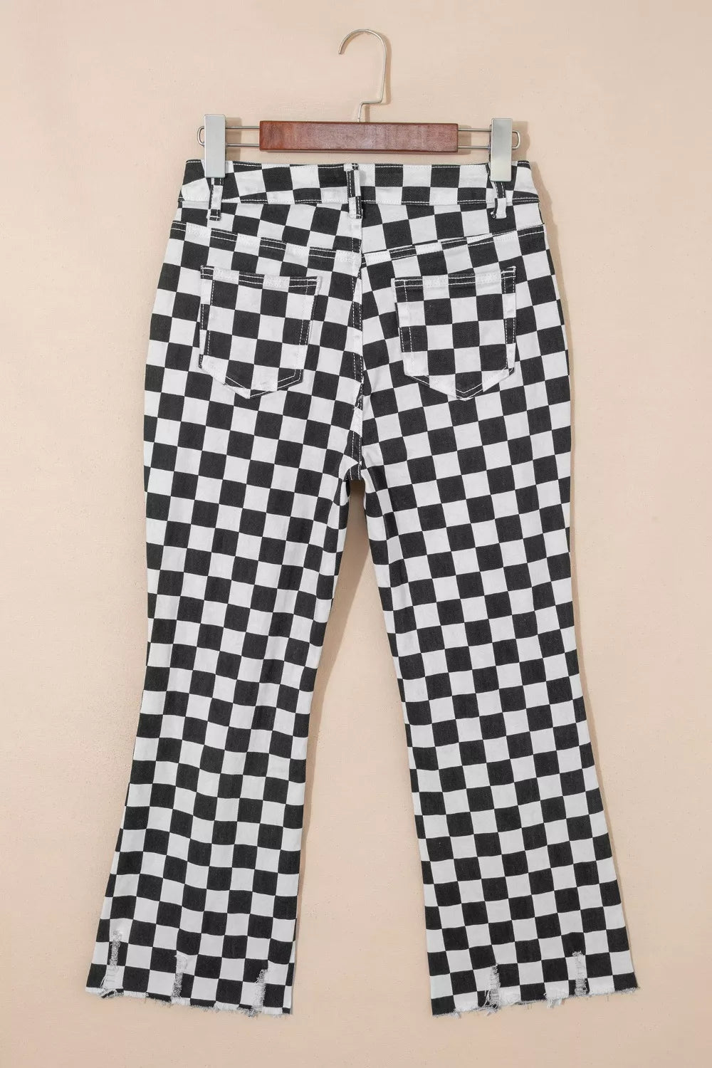 Women's checkerboard print distressed raw edge cropped jeans by Trendsi, featuring a modern, edgy design with frayed hems.